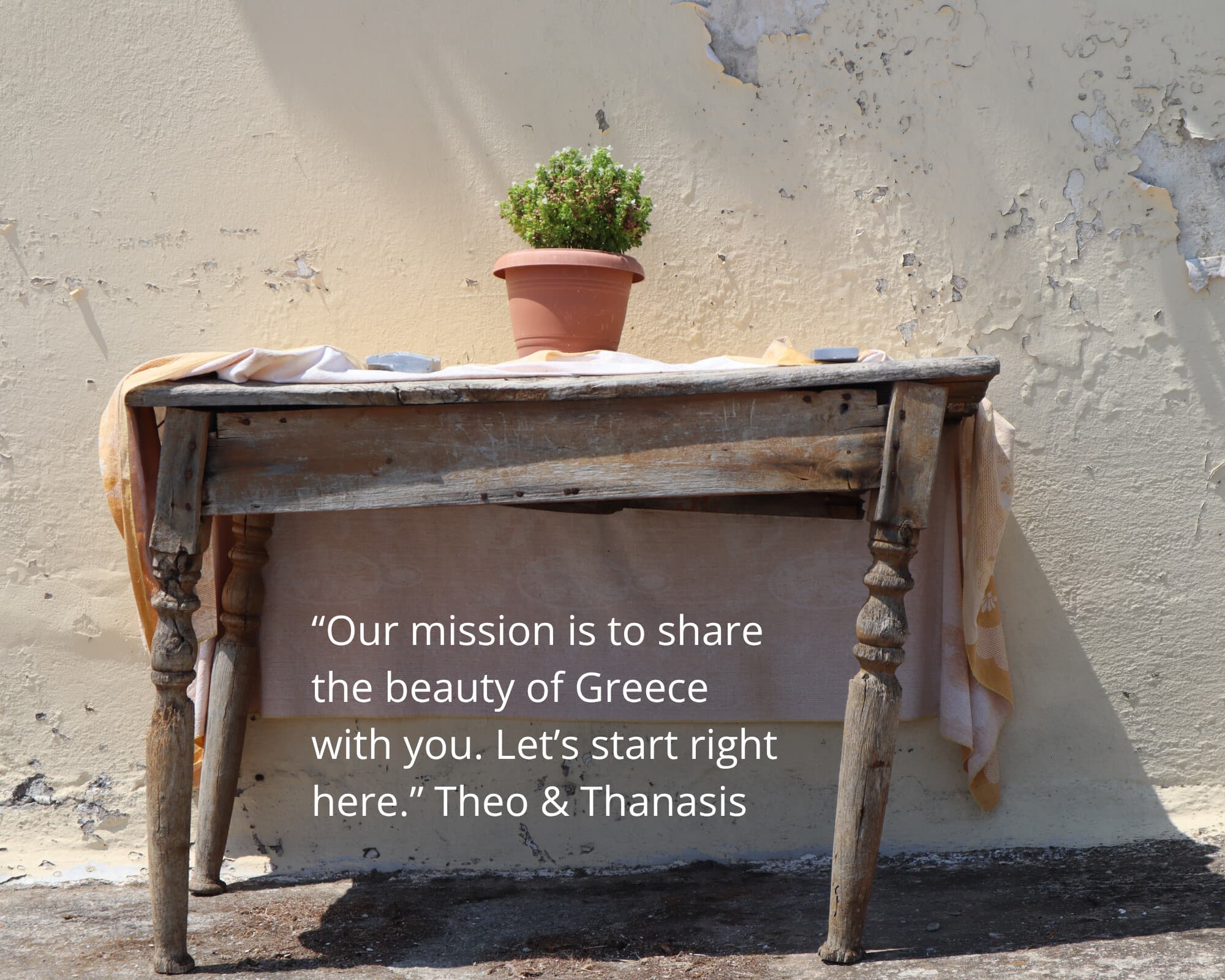 “Our mission is to share the beauty of Greece with you. Let’s start right here.” - a rustic table and potted plant in the Greek sun, Monobrow Holidays Greece
