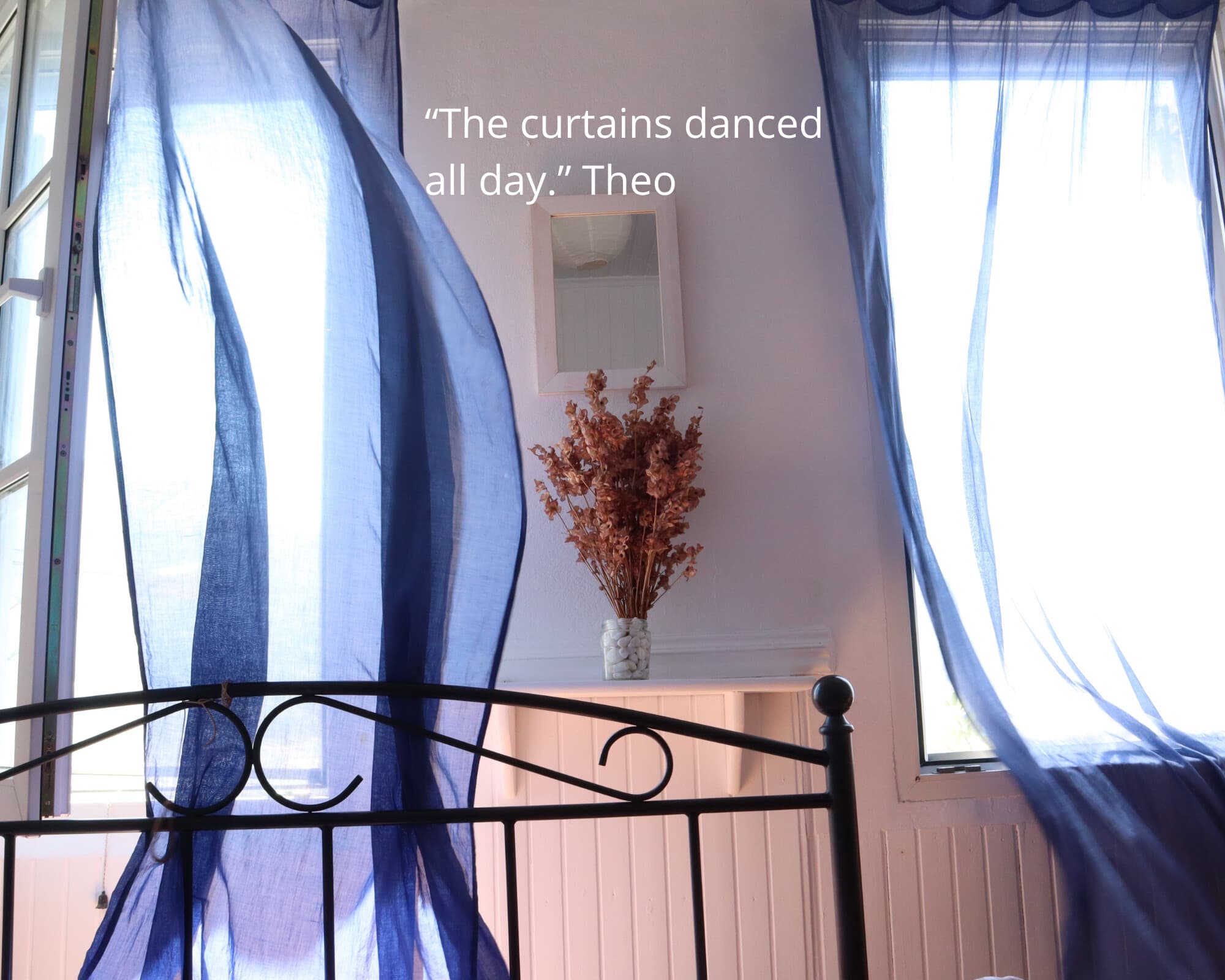 A stone house with dancing blue curtains on a Greek island - Monobrow Bespoke Tours